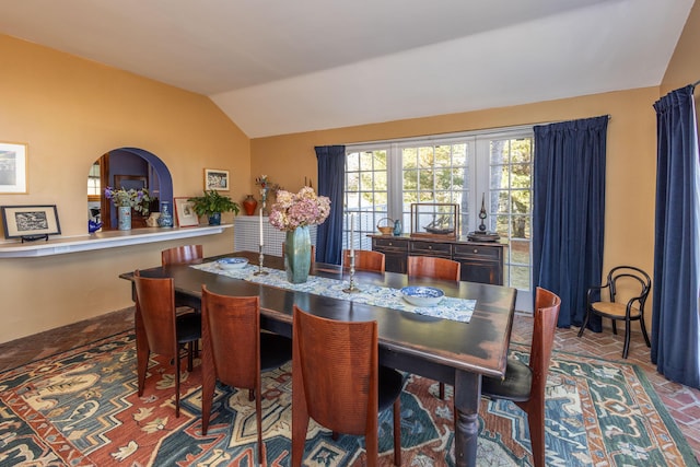 18 Bayside Dr, Belfast, ME 04915 - dining area featuring vaulted ceiling, arched walkways, and brick patterned flooring