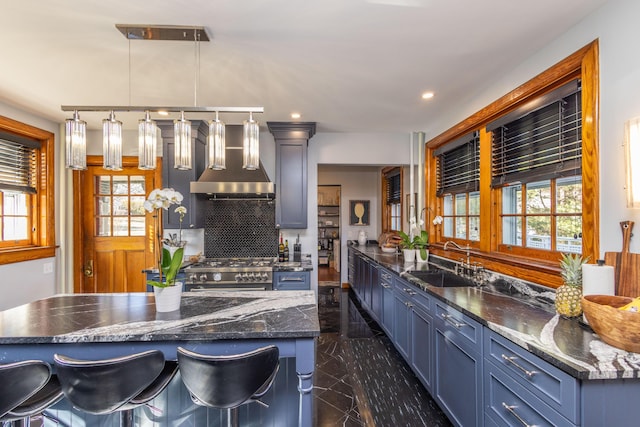 18 Bayside Dr, Belfast, ME 04915 - kitchen featuring high end stainless steel range, hanging light fixtures, recessed lighting, a breakfast bar, and dark stone counters