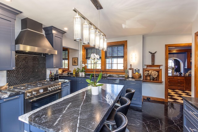 18 Bayside Dr, Belfast, ME 04915 - kitchen with wall chimney range hood, high end range, blue cabinetry, plenty of natural light, and recessed lighting