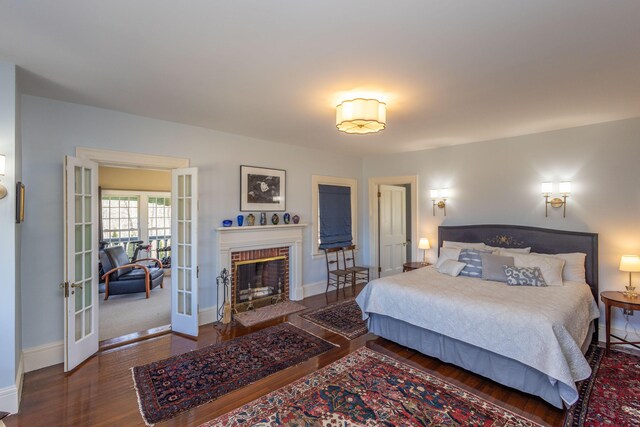 18 Bayside Dr, Belfast, ME 04915 - bedroom featuring french doors, wood finished floors, and a brick fireplace