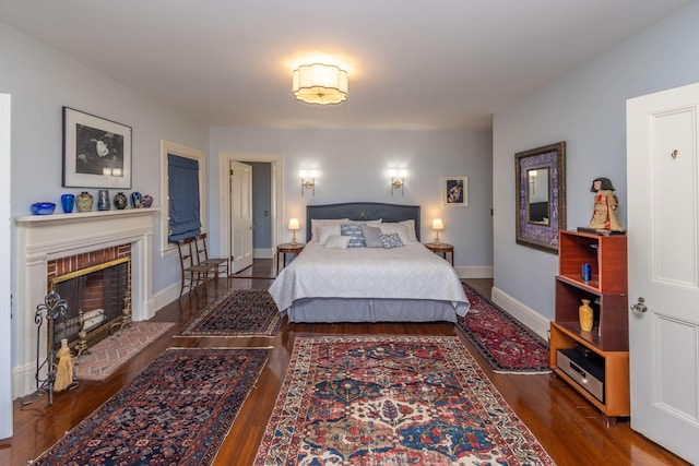 18 Bayside Dr, Belfast, ME 04915 - bedroom featuring wood finished floors and a brick fireplace