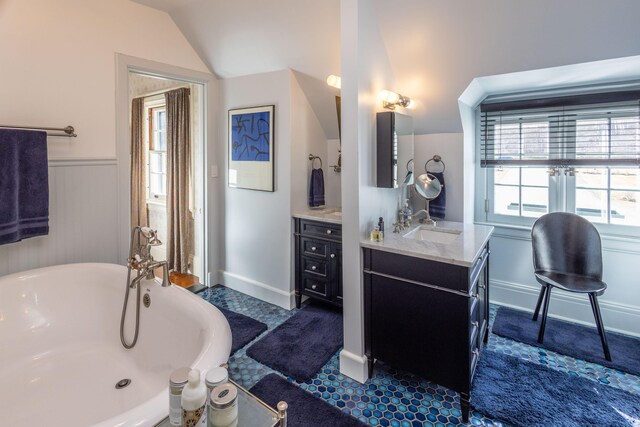 18 Bayside Dr, Belfast, ME 04915 - bathroom with vanity, a freestanding bath, lofted ceiling, and a wainscoted wall