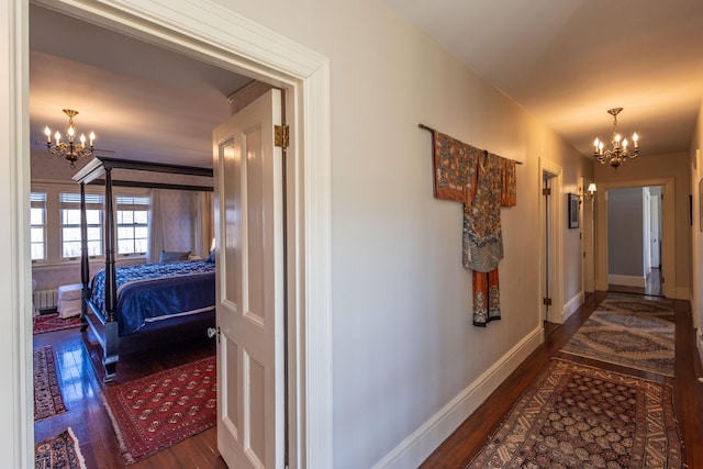 18 Bayside Dr, Belfast, ME 04915 - corridor with a chandelier, wood finished floors, and radiator heating unit