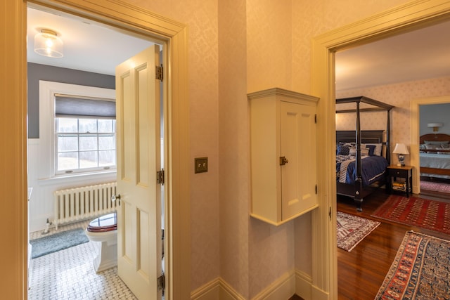 18 Bayside Dr, Belfast, ME 04915 - hallway with radiator heating unit, wallpapered walls, and wood finished floors