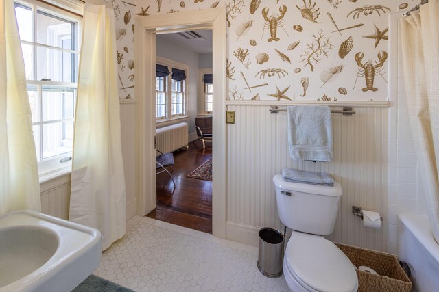 18 Bayside Dr, Belfast, ME 04915 - full bathroom with radiator, wallpapered walls, wainscoting, tile patterned flooring, and shower / bath combo with shower curtain