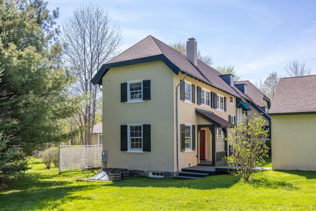 18 Bayside Dr, Belfast, ME 04915 - view of front of property featuring a chimney, stucco siding, and a front lawn