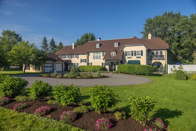 18 Bayside Dr, Belfast, ME 04915 - view of front of property featuring asphalt driveway, a garage, and a chimney