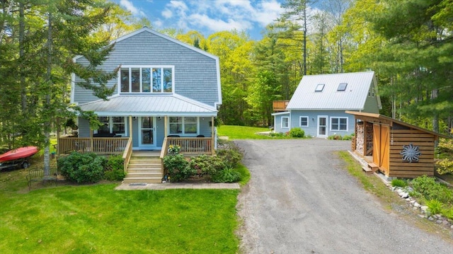 51 Four Wheel Dr, Brunswick, ME 04011 - view of front facade featuring covered porch, driveway, a metal roof, and a front yard