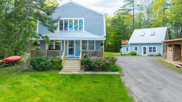 51 Four Wheel Dr, Brunswick, ME 04011 - view of front facade featuring a porch, dirt driveway, a front yard, a metal roof, and stairs