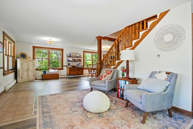 51 Four Wheel Dr, Brunswick, ME 04011 - living area with healthy amount of natural light, a baseboard radiator, wood finished floors, and stairs