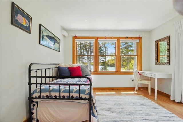 51 Four Wheel Dr, Brunswick, ME 04011 - bedroom featuring multiple windows, wood finished floors, and a wall unit AC