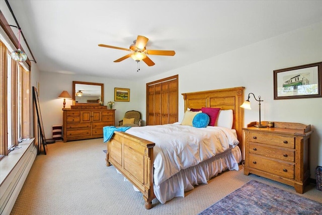 51 Four Wheel Dr, Brunswick, ME 04011 - bedroom featuring light carpet, a baseboard radiator, a closet, and a ceiling fan