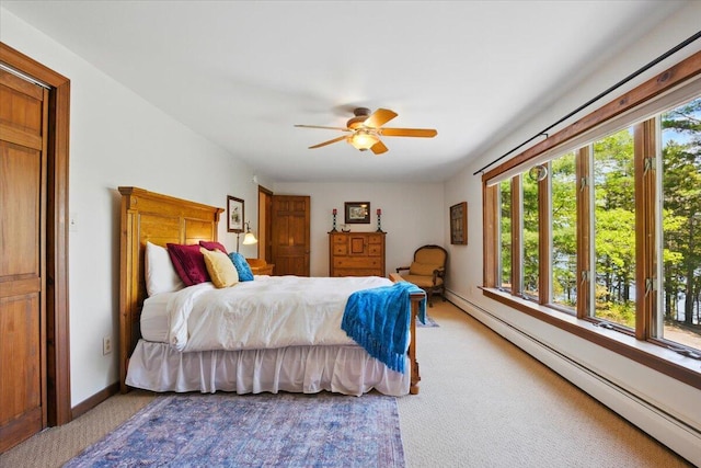 51 Four Wheel Dr, Brunswick, ME 04011 - bedroom featuring a baseboard heating unit, light carpet, and a ceiling fan