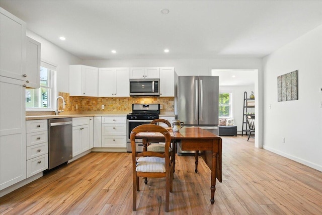 51 Four Wheel Dr, Brunswick, ME 04011 - kitchen with stainless steel appliances, light wood-style floors, backsplash, and recessed lighting