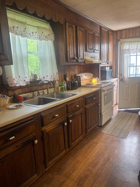 179 Raymond St, Pittsfield, ME 04967 - kitchen featuring white electric range, a sink, light countertops, dark wood-type flooring, and under cabinet range hood