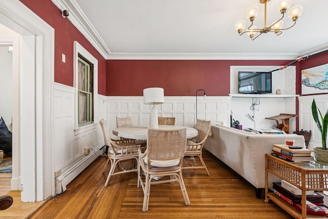 148 State St, Portland, ME 04101 - dining space with baseboard heating, crown molding, a chandelier, wainscoting, and hardwood / wood-style flooring