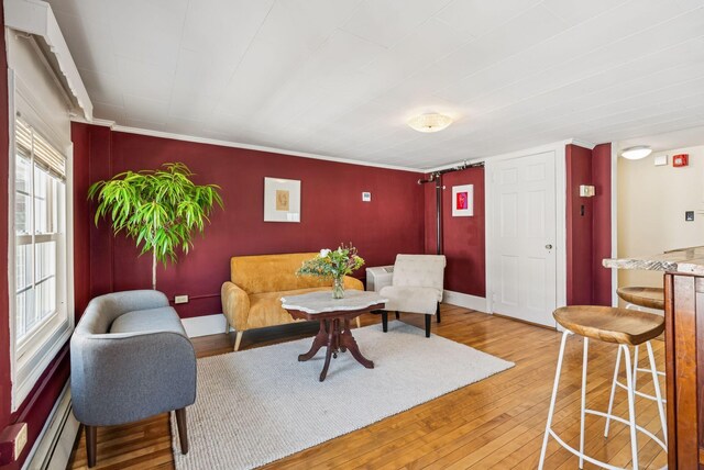 148 State St, Portland, ME 04101 - living room with a baseboard heating unit, hardwood / wood-style flooring, and ornamental molding