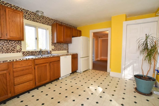 50 Baldwin Rd, Sebago, ME 04029 - kitchen featuring white appliances, a sink, decorative backsplash, and brown cabinetry