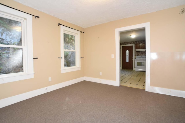 50 Baldwin Rd, Sebago, ME 04029 - empty room featuring dark colored carpet and baseboards