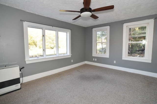 50 Baldwin Rd, Sebago, ME 04029 - empty room with a textured ceiling, ceiling fan, carpet flooring, baseboards, and heating unit
