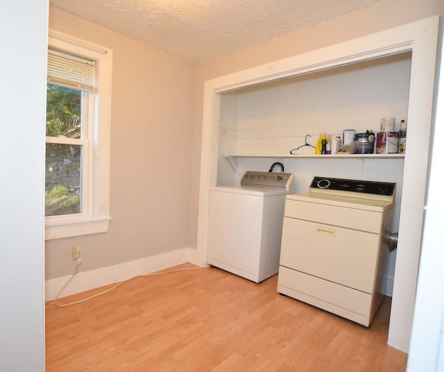 50 Baldwin Rd, Sebago, ME 04029 - washroom featuring light wood-type flooring, independent washer and dryer, a textured ceiling, and baseboards