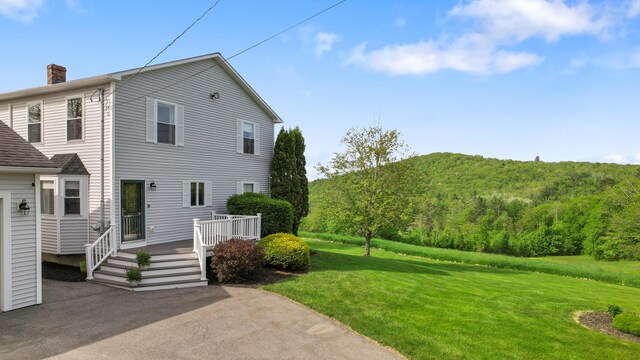 216 Monroe Rd, Winterport, ME 04496 - view of home's exterior with a chimney, a yard, and a deck
