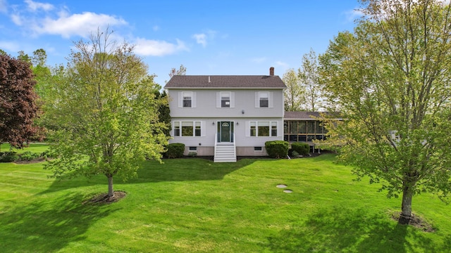216 Monroe Rd, Winterport, ME 04496 - back of house with a chimney, a lawn, entry steps, and a sunroom