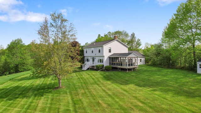 216 Monroe Rd, Winterport, ME 04496 - rear view of property featuring a sunroom, a chimney, and a lawn