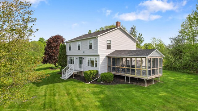 216 Monroe Rd, Winterport, ME 04496 - rear view of house featuring a sunroom, a chimney, and a yard