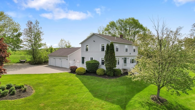 216 Monroe Rd, Winterport, ME 04496 - back of house featuring a lawn, a chimney, and concrete driveway