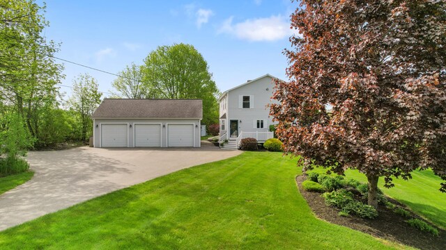 216 Monroe Rd, Winterport, ME 04496 - view of front of home with an outbuilding, a front yard, and a garage
