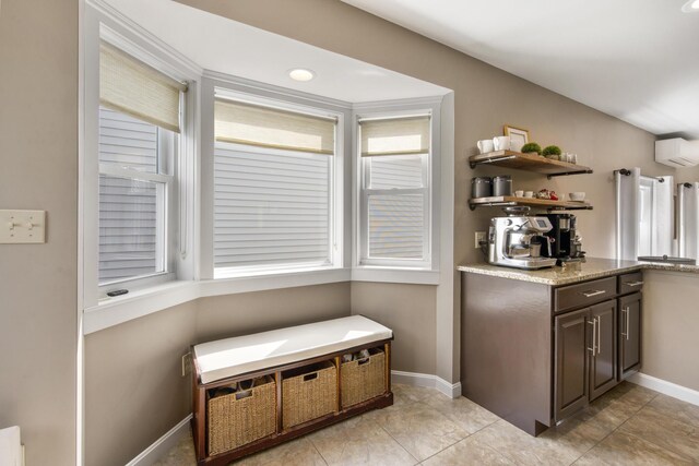 216 Monroe Rd, Winterport, ME 04496 - kitchen featuring an AC wall unit, dark brown cabinetry, baseboards, and open shelves