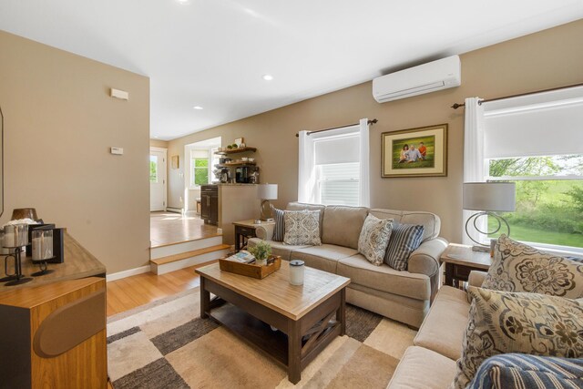 216 Monroe Rd, Winterport, ME 04496 - living area with a wall unit AC, light wood-style flooring, and recessed lighting