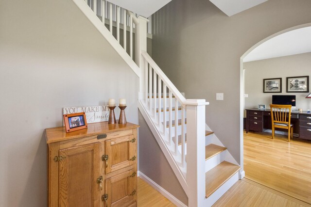 216 Monroe Rd, Winterport, ME 04496 - staircase featuring arched walkways and wood finished floors