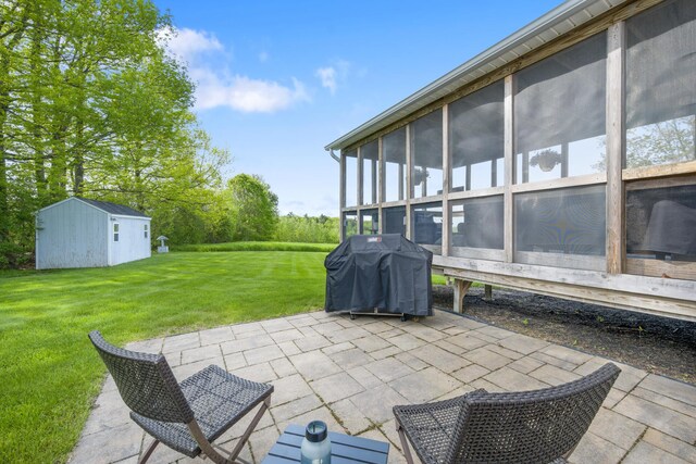 216 Monroe Rd, Winterport, ME 04496 - view of patio / terrace with area for grilling, an outbuilding, and a sunroom