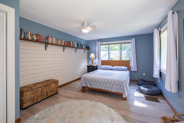 183 Buckfield Rd, Turner, ME 04282 - bedroom featuring wood finished floors, baseboards, a ceiling fan, and wooden walls