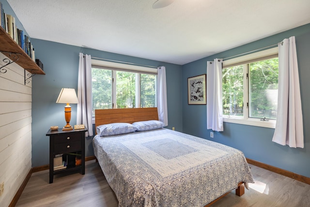 183 Buckfield Rd, Turner, ME 04282 - bedroom with multiple windows, wood finished floors, and baseboards
