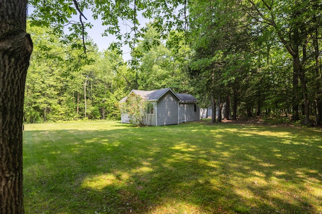 183 Buckfield Rd, Turner, ME 04282 - view of grassy yard featuring an outdoor structure and a wooded view