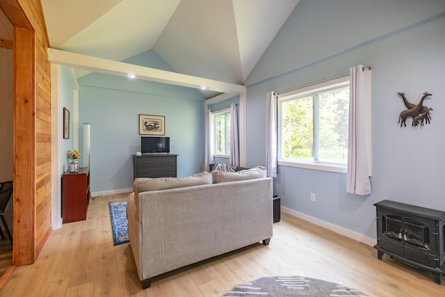 183 Buckfield Rd, Turner, ME 04282 - living room featuring a wood stove, light wood-style floors, lofted ceiling, and baseboards