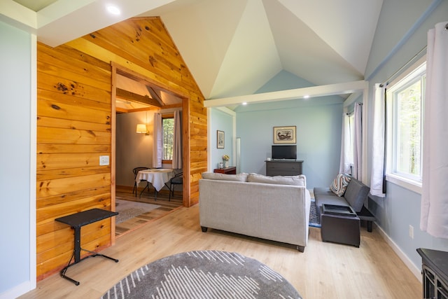 183 Buckfield Rd, Turner, ME 04282 - living area with plenty of natural light, light wood-type flooring, lofted ceiling, wooden walls, and baseboards
