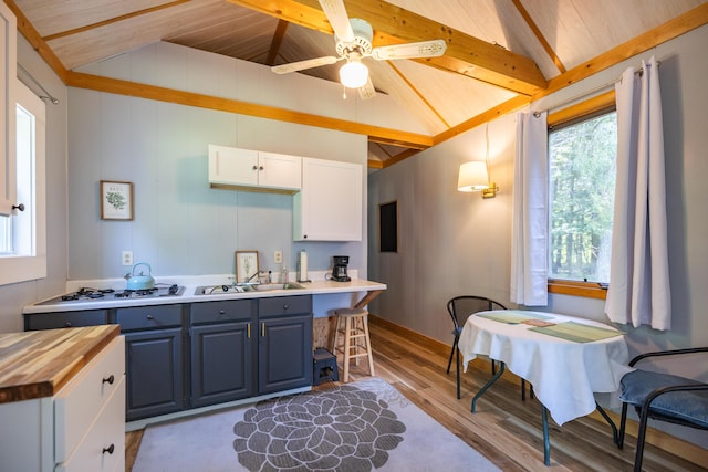 183 Buckfield Rd, Turner, ME 04282 - kitchen featuring wooden counters, light wood-type flooring, a sink, white cabinets, and blue cabinetry