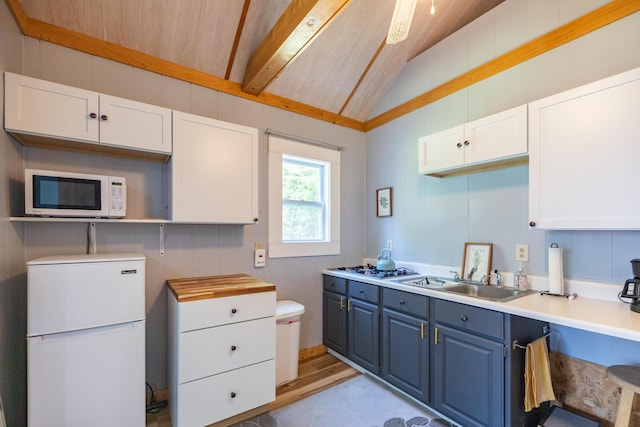 183 Buckfield Rd, Turner, ME 04282 - kitchen featuring white appliances, blue cabinetry, a sink, light wood-style floors, and white cabinetry
