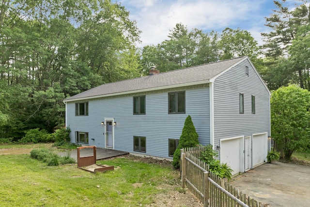 32 Long Hall Dr, Berwick, ME 03901 - back of property featuring an attached garage, a chimney, concrete driveway, and a shingled roof