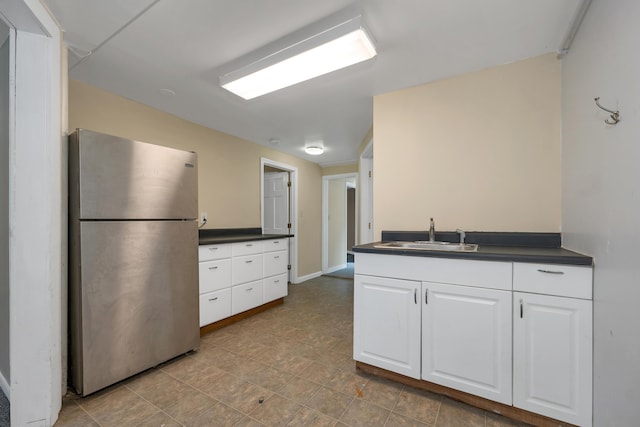 32 Long Hall Dr, Berwick, ME 03901 - kitchen with freestanding refrigerator, dark countertops, and white cabinetry