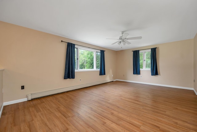 32 Long Hall Dr, Berwick, ME 03901 - unfurnished room featuring baseboard heating, plenty of natural light, a ceiling fan, and light wood-style floors