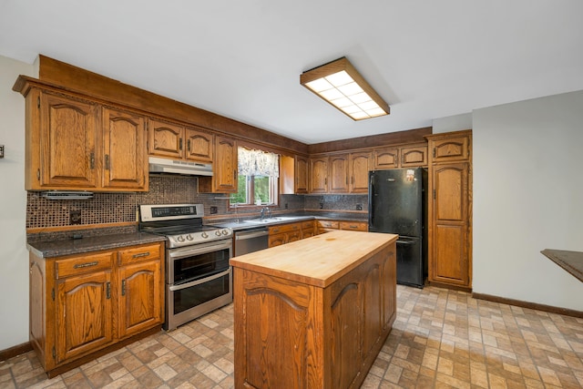 32 Long Hall Dr, Berwick, ME 03901 - kitchen with stainless steel appliances, under cabinet range hood, brick patterned floors, and butcher block counters