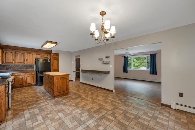 32 Long Hall Dr, Berwick, ME 03901 - kitchen featuring freestanding refrigerator, a baseboard heating unit, brick patterned floors, and stainless steel range
