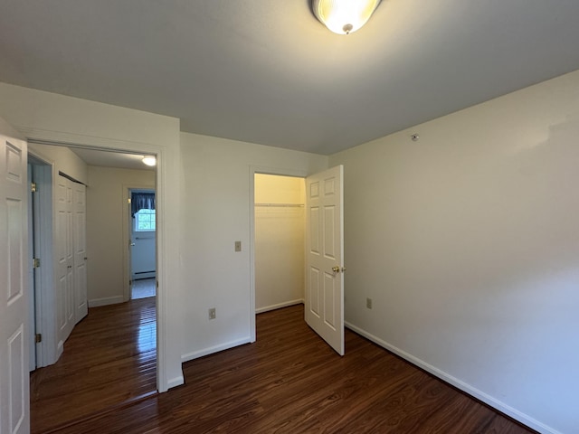 541 Kenduskeag Ave Unit A1, Bangor, ME 04401 - unfurnished bedroom with dark wood-type flooring, baseboards, and a closet