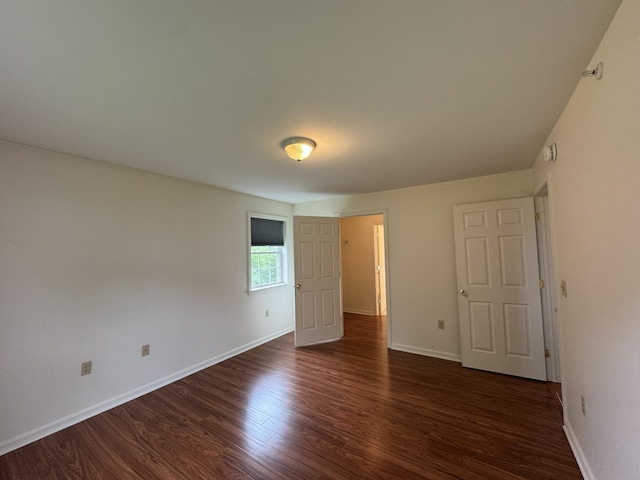 541 Kenduskeag Ave Unit A1, Bangor, ME 04401 - unfurnished bedroom with dark wood-type flooring and baseboards