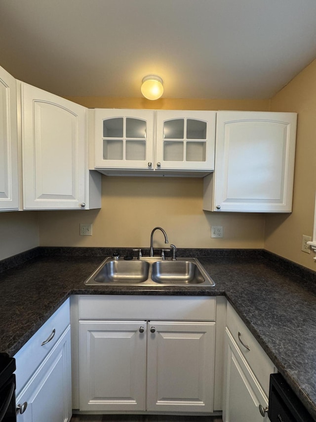 541 Kenduskeag Ave Unit A1, Bangor, ME 04401 - kitchen with a sink, white cabinetry, dishwashing machine, dark countertops, and glass insert cabinets